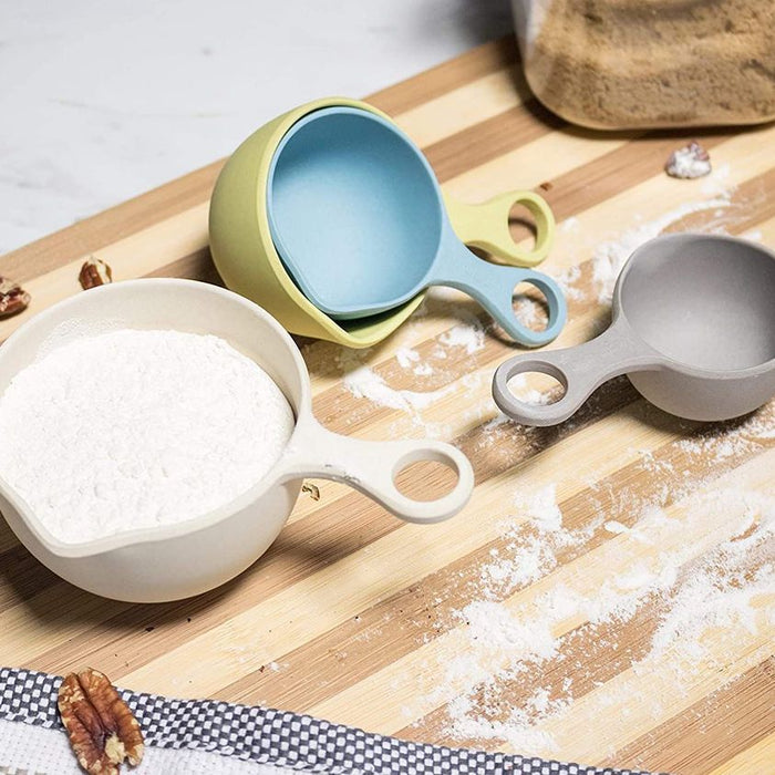 Bamboozle Measuring Cups on Cutting Board Sprinkled with Flour