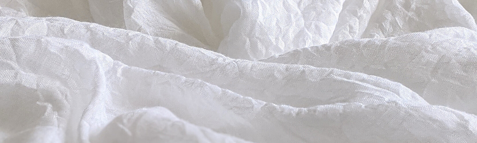 Closeup of White Bedsheets that Look Like Waves