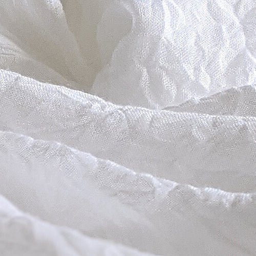 Closeup of White Bedsheets that Look Like Waves